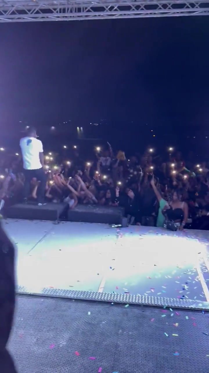 Concert stage and crowd with phone lights